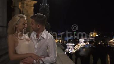 在古城背景下，一对情侣在阳台上接吻